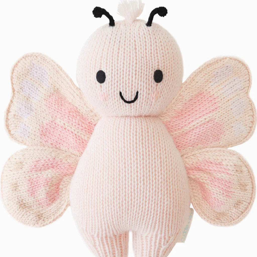 pink butterfly stuffy flat lay