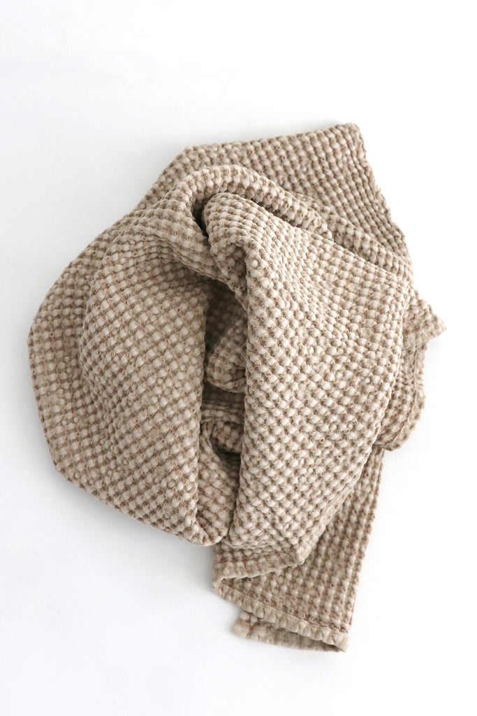 Woven fabric with a checkered pattern on a white background