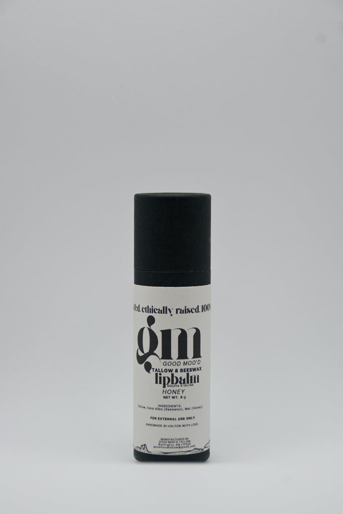 Skincare product bottle with black cap and white label on a gray background
