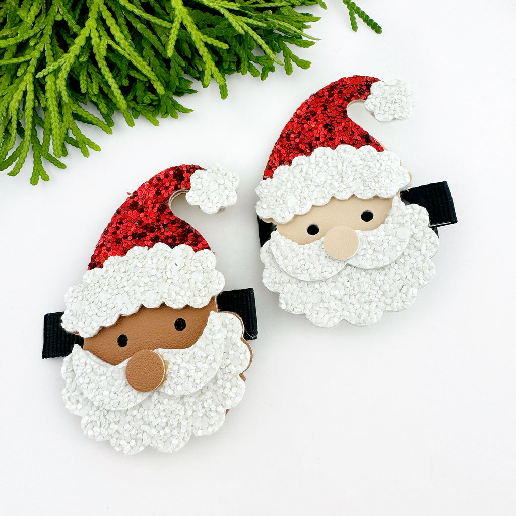 Two santa hair clips flat lay