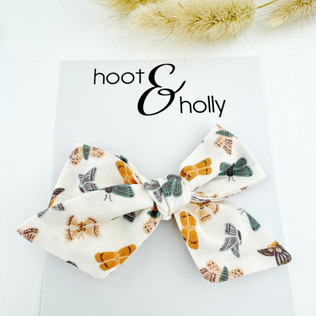 Butterflies and white bow flat lay