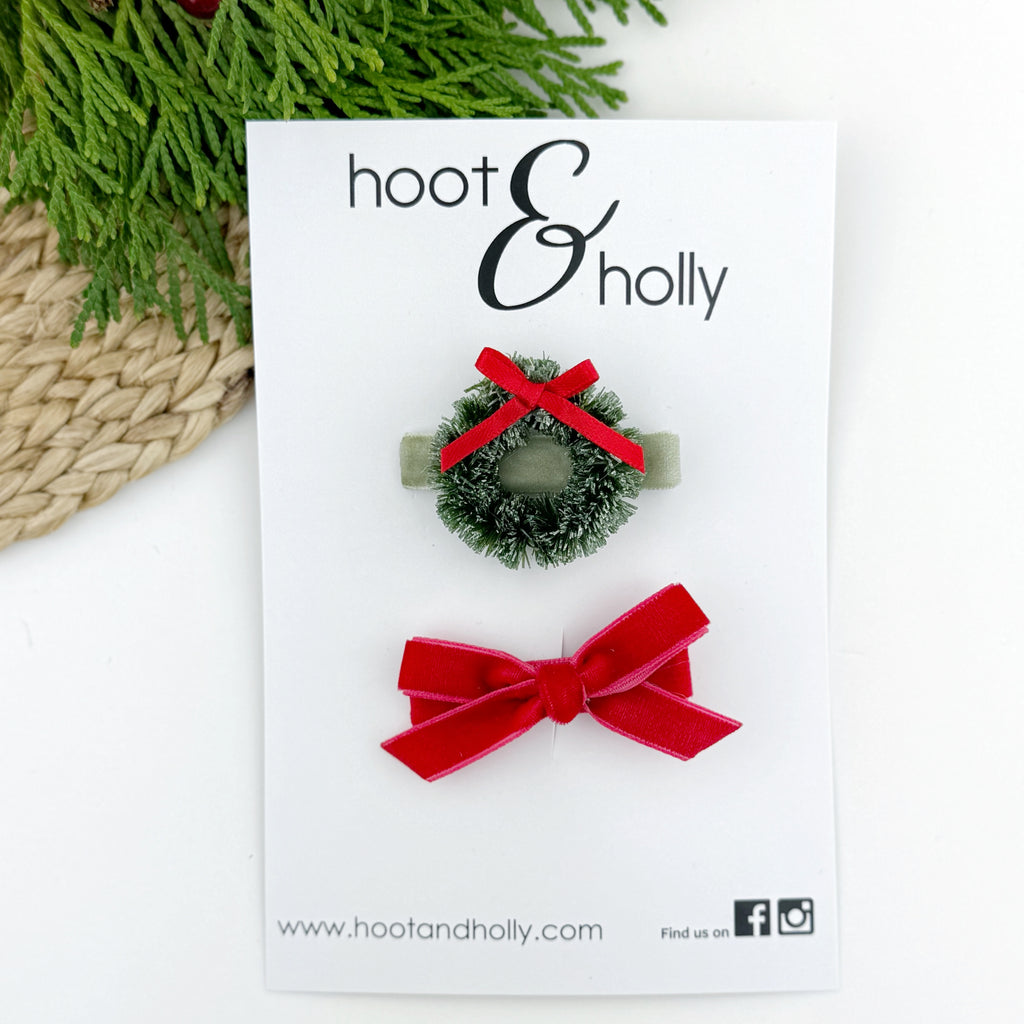 Green wreath hair clip and red hair clip flat lay