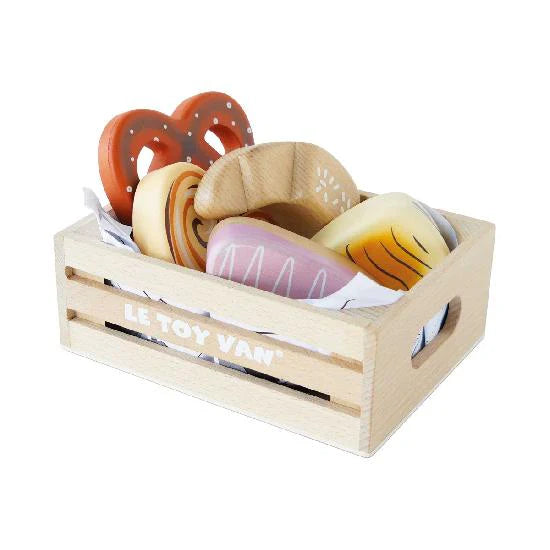 Wooden bread and pretzel in wooden basket.
