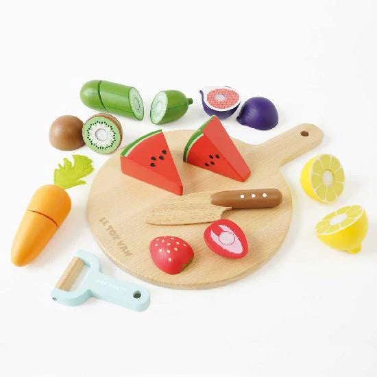 Cucimber, kiwi,watermelon, lemon,carrot, peeler, strawberry,onion & cutting board flat lay