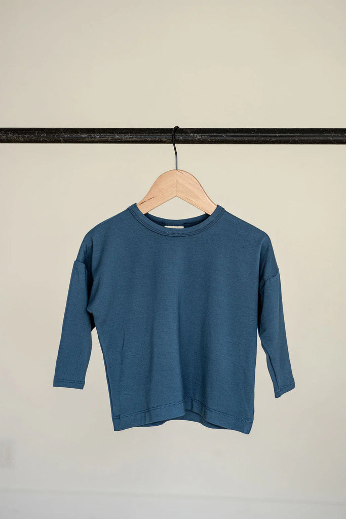 Blue long sleeve t-shirt hanging on a hanger