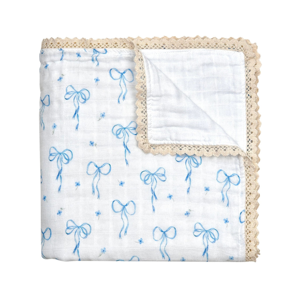 Baby blanket with blue bow pattern and beige crochet border on a white background