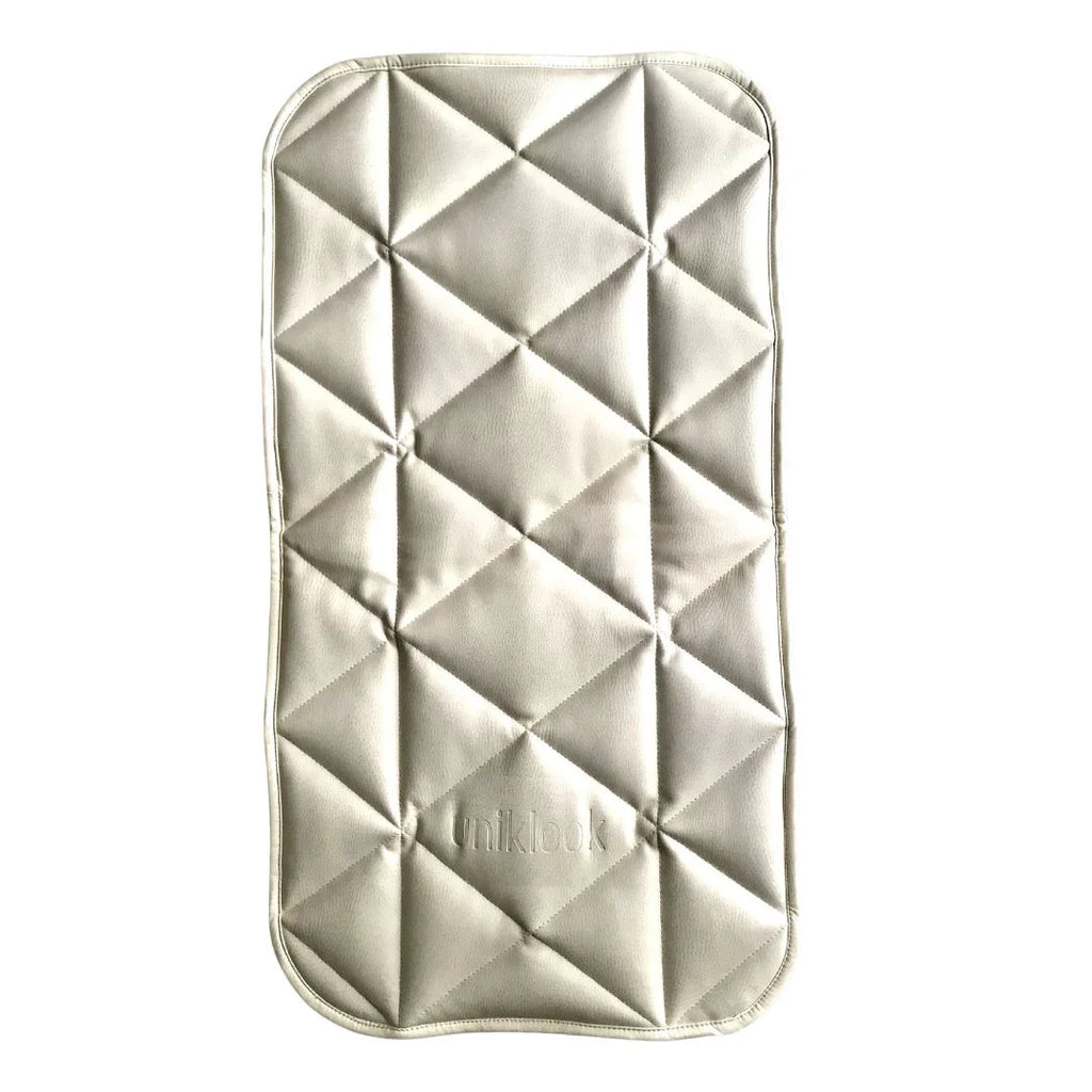 Quilted rectangular pad with geometric pattern on a white background