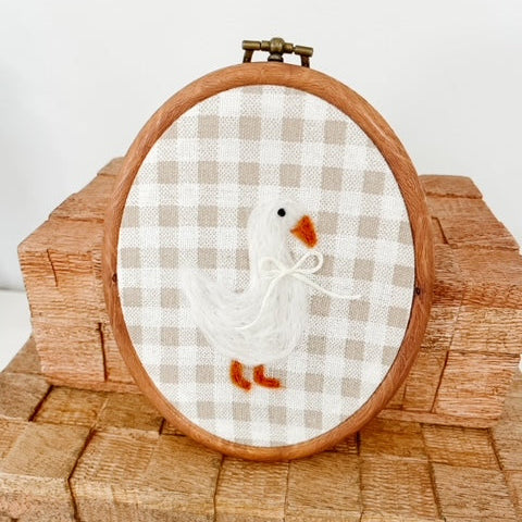 oval hoop bird wool art with checkered background
