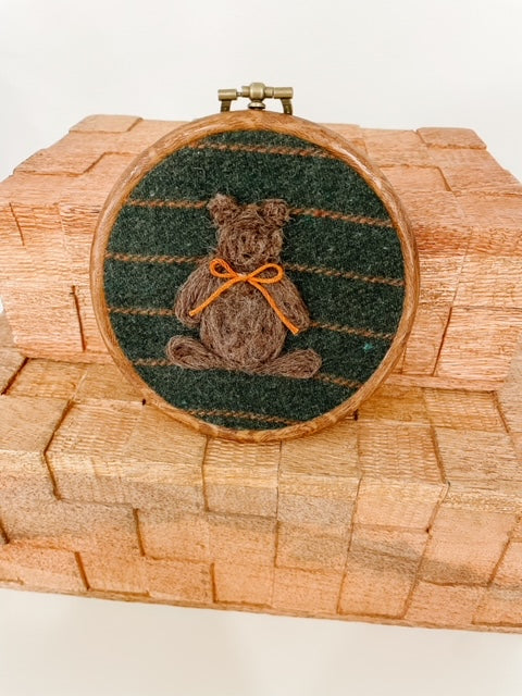 circle wool art with bear and yellow bow