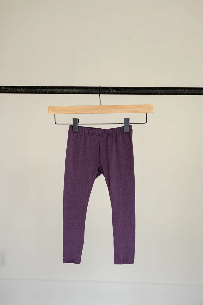 Purple leggings hanging on a hanger